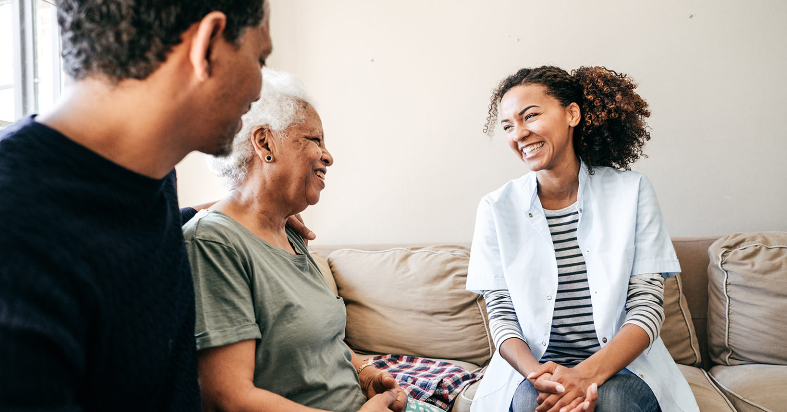 Nurse visiting senior lady at home