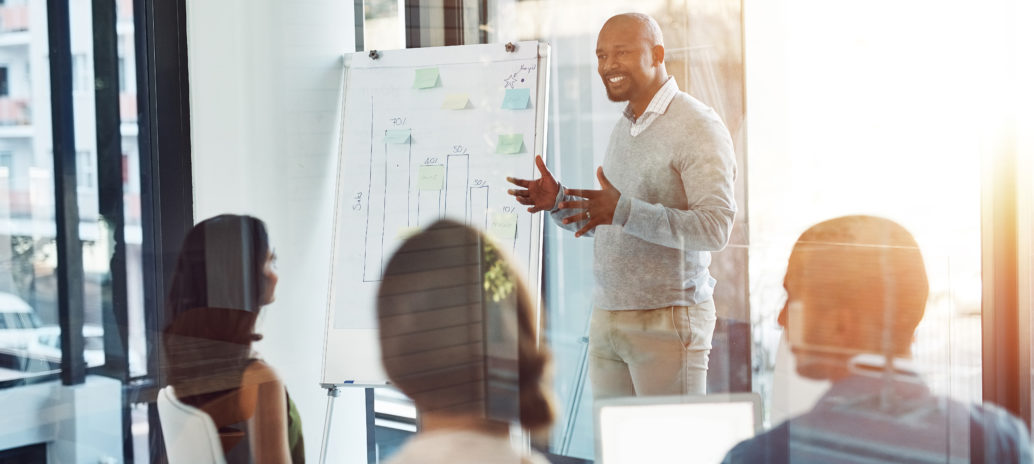 man presenting with a graphic whiteboard