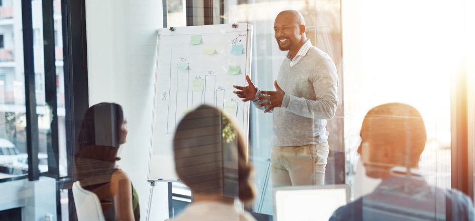 man presenting with a graphic whiteboard