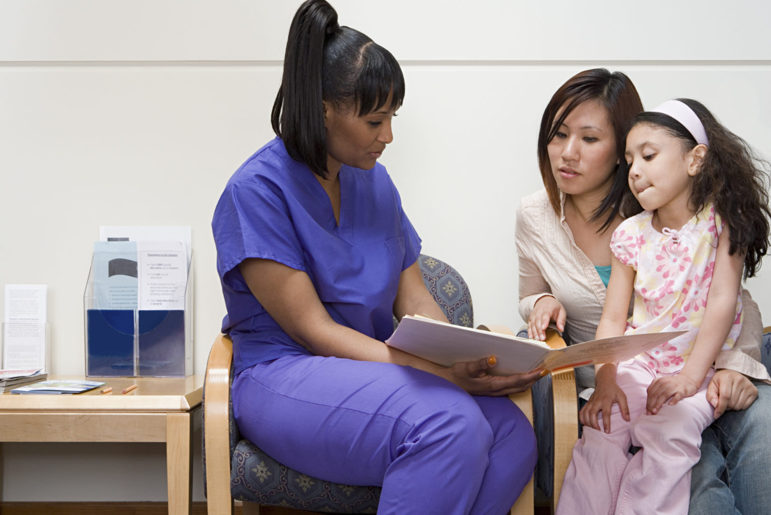 Nurse talking to mother and daughter