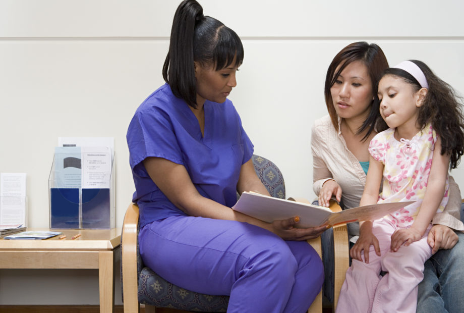 Nurse talking to mother and daughter