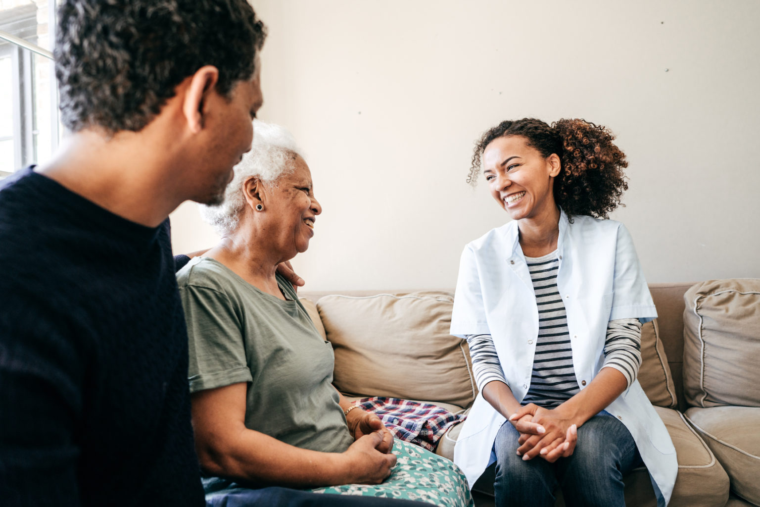 Nurse visiting senior lady at home